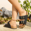 Casual green Birkenstock-style sandals on woven mat